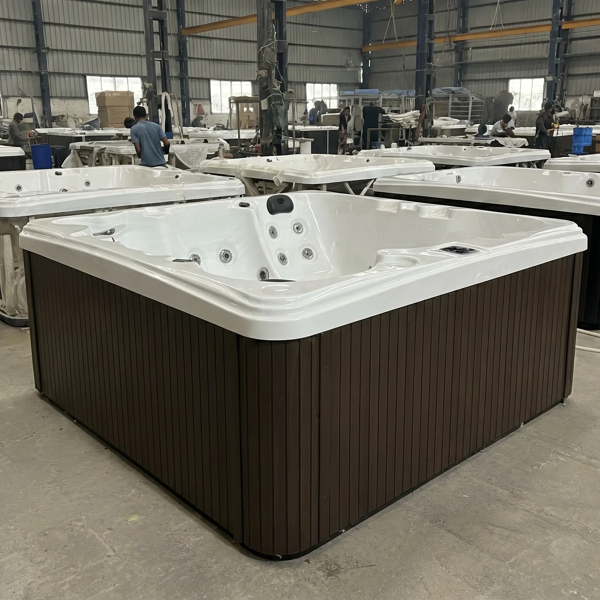 Hot tubs being assembled in a manufacturing workshop